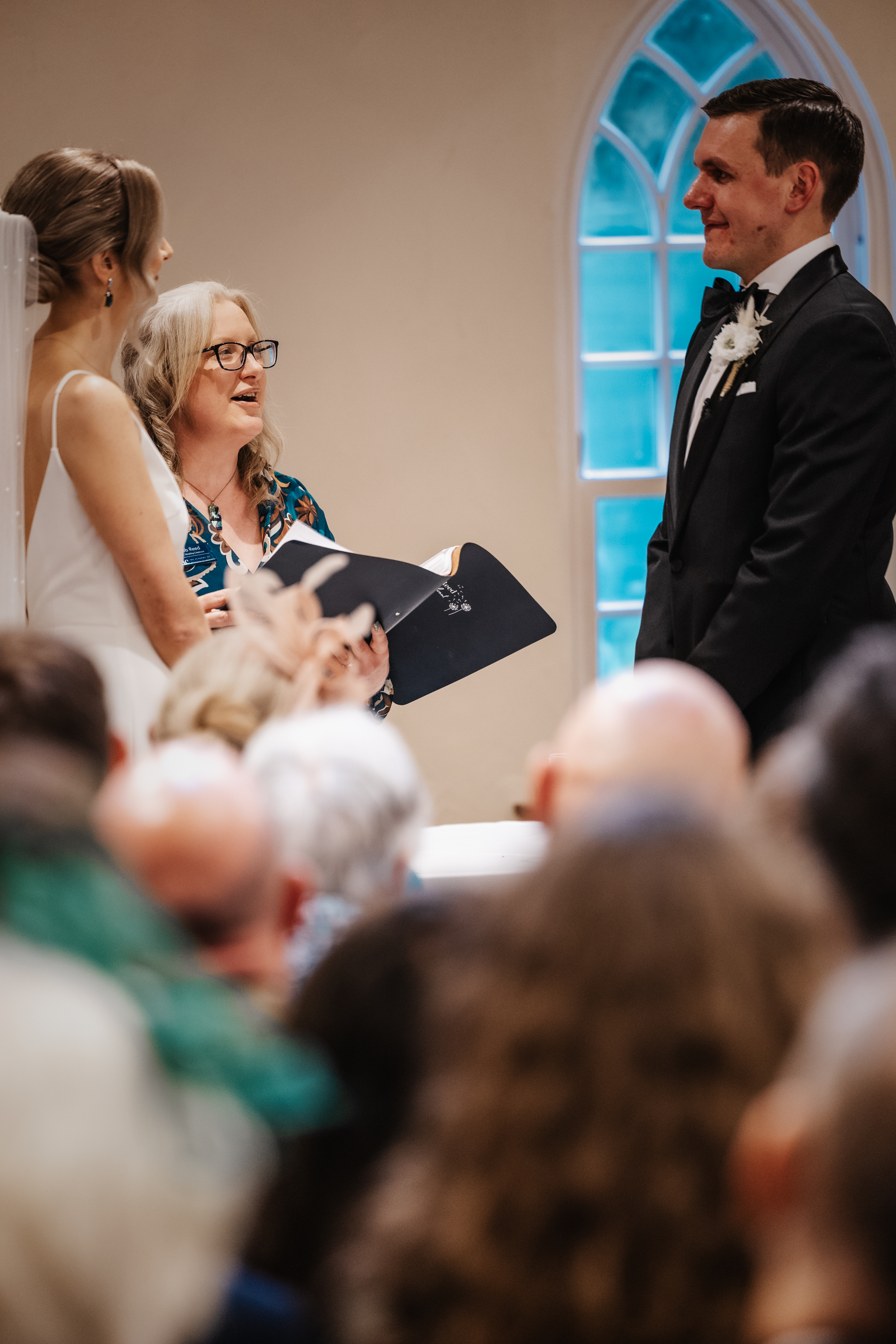 Deb Reed Celebrant Colchester Essex, officiating at the wedding of Cheyney and Albert during their first kiss.
